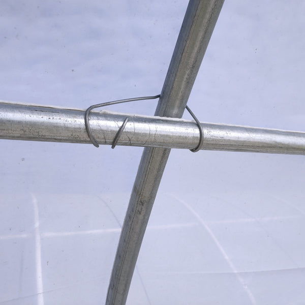 Metal pipe with a wire wrapped around it on a light gray background
