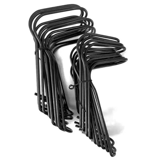 Set of black metal hooks stacked on a white background