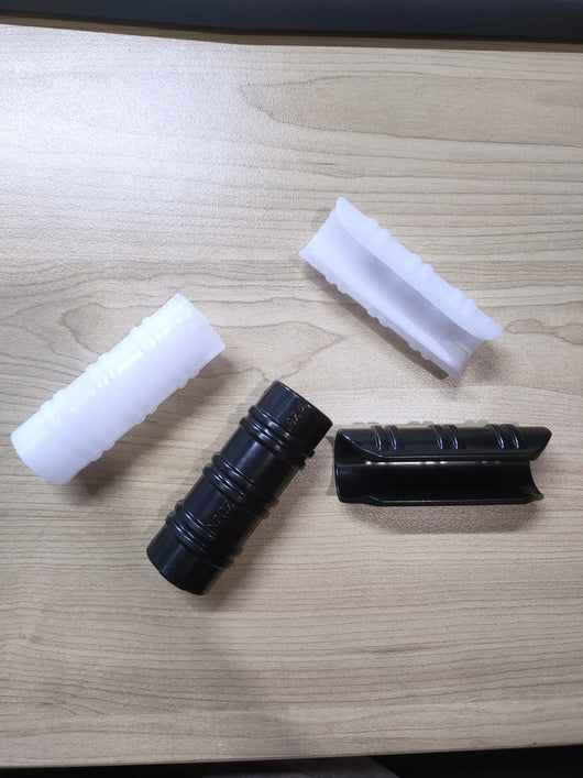 Black and white tube clips on a wooden surface